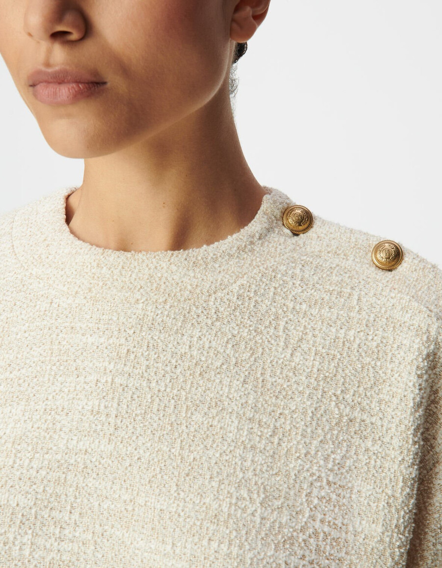 damessweatshirt van beige lurex tweed met knoopsluiting op de schouders.