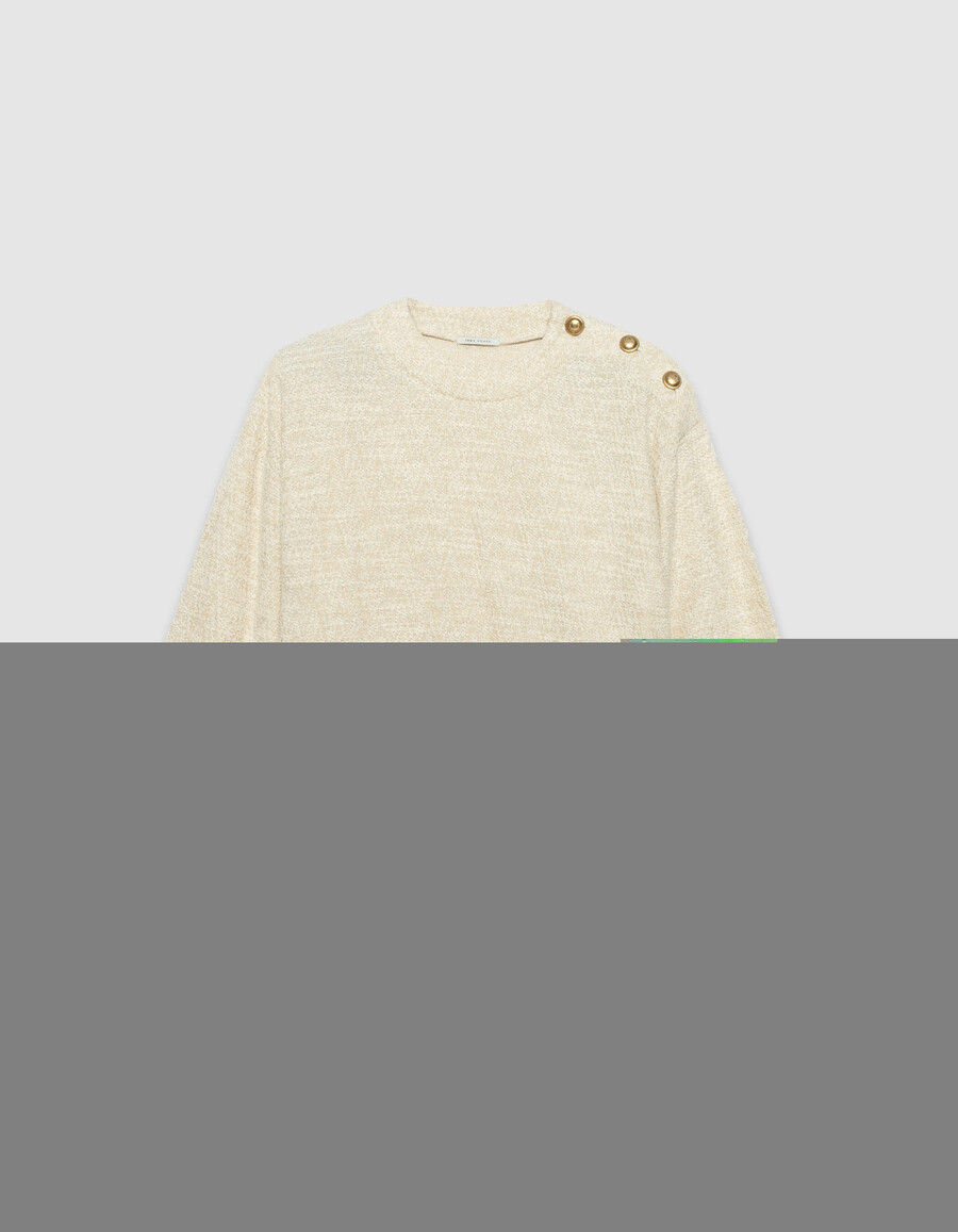 damessweatshirt van beige lurex tweed met knoopsluiting op de schouders.